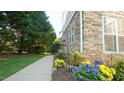 Landscaped walkway featuring colorful flowers leading to the home's entrance at 5901 Chivalry Ct, Raleigh, NC 27612