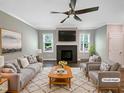Bright living room featuring a cozy fireplace, modern ceiling fan, and stylish neutral decor at 6245 Reagan Ln, Wake Forest, NC 27587