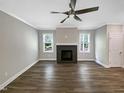 Bright living room with a dark stone fireplace and hardwood floors, perfect for relaxation and entertaining at 6245 Reagan Ln, Wake Forest, NC 27587