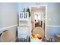 Bright dining area with a glass table, a decorative hutch, and a view into the living space at 861 Dalewood Dr, Raleigh, NC 27610