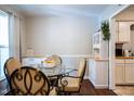 Bright dining room with dark flooring featuring a round table, hutch, and natural light at 861 Dalewood Dr, Raleigh, NC 27610