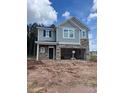 New two-story home showing stone accents, double garage, siding, and a neatly arranged window layout at 1003 Shovelhead Dr # 2, Durham, NC 27703