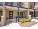 Brick townhome entrance with a modern front door and manicured landscaping at 1012 Manor Way, Durham, NC 27701