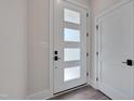 Modern white front door with glass panels, showcasing contemporary design elements at 1012 Manor Way, Durham, NC 27701