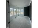 Living room with white wall trim, a black accent wall, and bright windows at 1021 Azalea Garden Cir, Raleigh, NC 27603