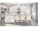 Bright kitchen features a large center island with barstool seating, stainless steel appliances, and ample storage at 1044 Country Pasture Cv, Wendell, NC 27591