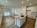 Open-concept kitchen with granite countertops, stainless steel appliances, and hardwood floors at 10527 Brookside Reserve Rd, Raleigh, NC 27614