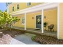 Inviting front porch with a blue door, white columns, and a quaint seating area at 109 Bessemer Pl, Durham, NC 27712