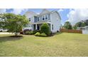 Expansive front lawn view showcasing the home's exterior, vibrant landscaping, and well-maintained surroundings at 1209 Redwood Valley Ln, Knightdale, NC 27545