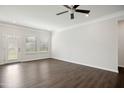 Spacious living room with wood floors, fan, and a door leading to the outside at 1316 London Meadow Way, Fuquay Varina, NC 27526