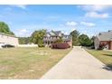 Charming two-story brick home featuring a welcoming front porch and a long driveway at 192 Crestdale Dr, Clayton, NC 27520
