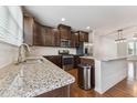 Modern kitchen features granite countertops, stainless steel appliances, and ample cabinet space at 2027 Hayes Ln, Holly Springs, NC 27540