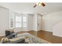 Inviting living room featuring hardwood floors, large windows, and comfortable seating at 2027 Hayes Ln, Holly Springs, NC 27540