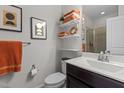 Modern bathroom featuring stylish shelving with towels, elegant decor, and a sleek vanity at 212 Allister Dr, Raleigh, NC 27609