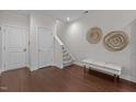 Entryway with hardwood floors, staircase, bench, and decorative wall art at 212 Allister Dr, Raleigh, NC 27609
