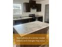 Modern kitchen featuring stainless steel appliances, granite countertops, and dark wood cabinetry at 212 Ellington Path, Henderson, NC 27537