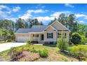 Beautiful single-story home with attached garage, manicured lawn, and beautiful, colorful landscaping at 215 Oxfordshire Dr, Fuquay Varina, NC 27526
