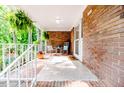 Inviting covered porch with decorative hanging plants and a cozy seating area at 2307 Piedmont Dr, Sanford, NC 27330