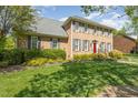 Attractive brick home with manicured lawn, shrubbery, and a classic red front door at 2545 Churchill Dr, Burlington, NC 27215