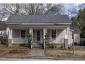 Inviting home facade featuring a quaint porch, decorative columns, and freshly landscaped front yard at 305 Freeman St, Raleigh, NC 27601