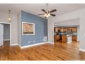 Open-concept living room with hardwood floors, accented wall, and seamless flow into the kitchen at 305 Freeman St, Raleigh, NC 27601