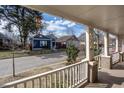 View from the covered front porch looking out onto a peaceful residential street and neighboring homes at 305 Freeman St, Raleigh, NC 27601