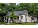 Quaint single-story home with a well-kept lawn and lush trees surrounding the property at 305 Freeman St, Raleigh, NC 27601