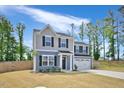 Inviting two-story home with fresh landscaping and a well-manicured lawn, perfect for families at 390 Hunting Wood Dr, Angier, NC 27501