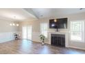 Bright living room featuring a fireplace and large windows at 395 Carolina Landing Dr, Zebulon, NC 27597