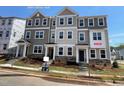 New two-story townhome features a stone facade, neutral siding and professionally landscaped yard at 4004 Silver Oak Ln, Durham, NC 27703