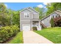 Charming two-story home with a one-car garage and beautifully landscaped front yard at 419 E East Hinton St, Clayton, NC 27520