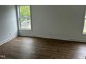 Well-lit bedroom featuring hardwood flooring and natural light from the window at 427 Lakeland St, Durham, NC 27701