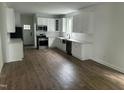 Bright kitchen featuring white cabinets, stainless appliances, and hardwood flooring at 427 Lakeland St, Durham, NC 27701