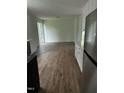 Open-concept living room with hardwood floors, stainless refrigerator, and sliding glass doors at 427 Lakeland St, Durham, NC 27701
