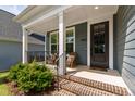 Inviting front porch with brick steps, stylish seating, and a view of the beautifully landscaped front yard at 4412 Powell Grove Ct, Raleigh, NC 27606