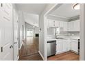 Well-lit kitchen area with stainless steel appliances flowing into an open-concept living space at 5000 Avenida Del Sol Dr, Raleigh, NC 27616