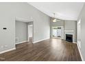 Large living room featuring wood floors, fireplace, fan, and open concept at 5000 Avenida Del Sol Dr, Raleigh, NC 27616