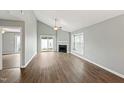 Bright living room with a fireplace, ceiling fan, and sliding door to outdoor space at 5000 Avenida Del Sol Dr, Raleigh, NC 27616
