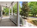 Covered front porch showing white railings and columns with views of the front yard and street at 504 Cameron Glen Dr, Apex, NC 27502