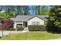 Inviting single-story home with a gray exterior, well-manicured lawn, shrubbery and a charming front porch at 508 2Nd Street St, Apex, NC 27502