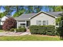 Quaint one-story home featuring well-kept landscaping, a charming porch, and neutral-colored siding at 508 2Nd Street St, Apex, NC 27502