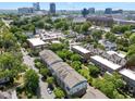 An aerial view showcases the neighborhood with tree-lined streets and the cityscape in the distance at 511 N Person St # 101, Raleigh, NC 27604