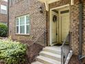 Brick entryway with decorative wreath and black iron railing at 511 N Person St # 101, Raleigh, NC 27604