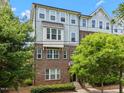 Beautiful three-story townhome featuring a combination of brick and siding, plus manicured landscaping at 511 N Person St # 101, Raleigh, NC 27604