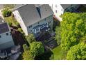 Aerial view of a home with a wooden deck, a cozy fire pit, and a lush garden at 5605 Cary Glen Blvd, Cary, NC 27519