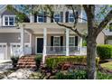 Charming front porch with white columns, brick steps, and inviting rocking chairs at 5605 Cary Glen Blvd, Cary, NC 27519