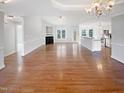 Bright, open-concept living space features a fireplace and hardwood floors at 62 Sailfish Ct, Clayton, NC 27520