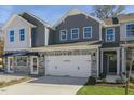 Charming two-story home with gray siding, stone accents, and a convenient attached two-car garage at 714 Andrade Dr, Fuquay Varina, NC 27526