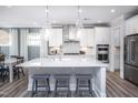 A well-appointed kitchen featuring sleek countertops, stainless steel appliances, and stylish pendant lighting at 755 Bachelor Gulch Way, Apex, NC 27523