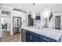Kitchen island with seating, stainless steel appliances, and stylish pendant lights at 756 Bachelor Gulch Way, Apex, NC 27523